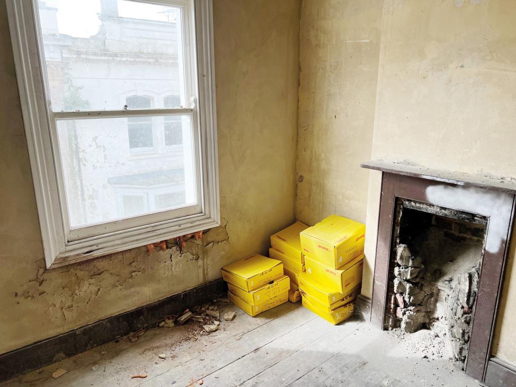 Room requiring refurbishment looking towards firep