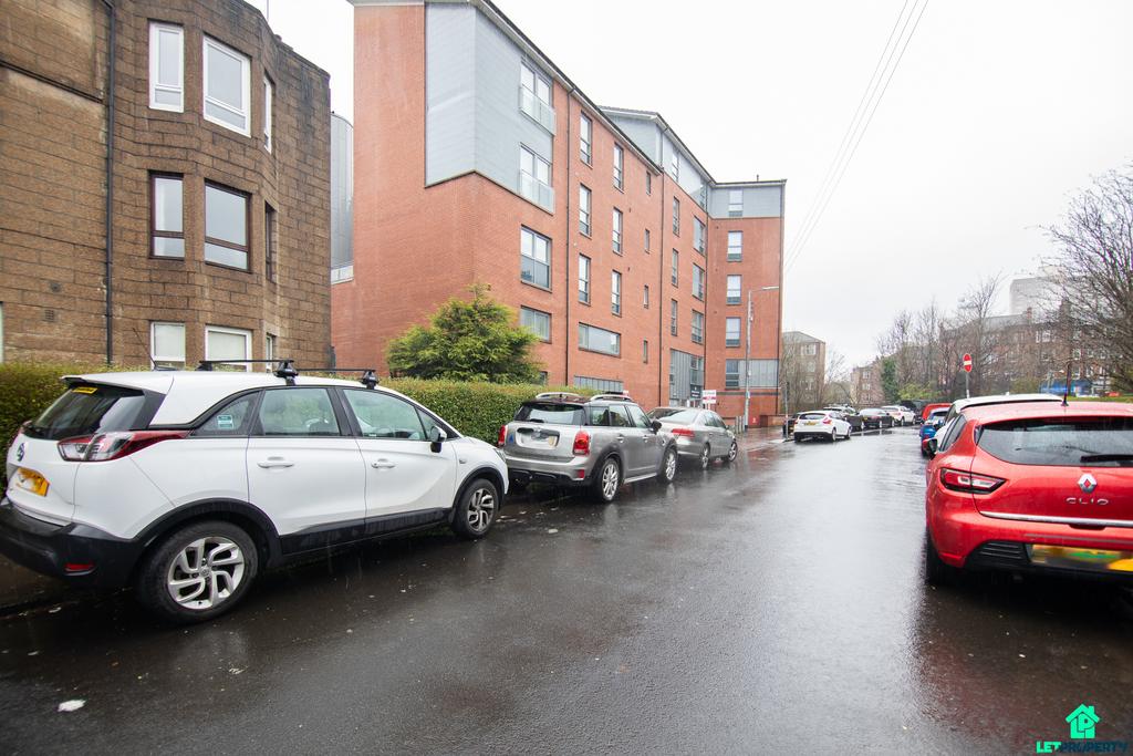 Street scene with property, parking