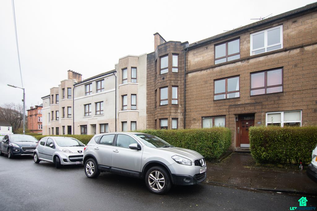Street scene with property, parking