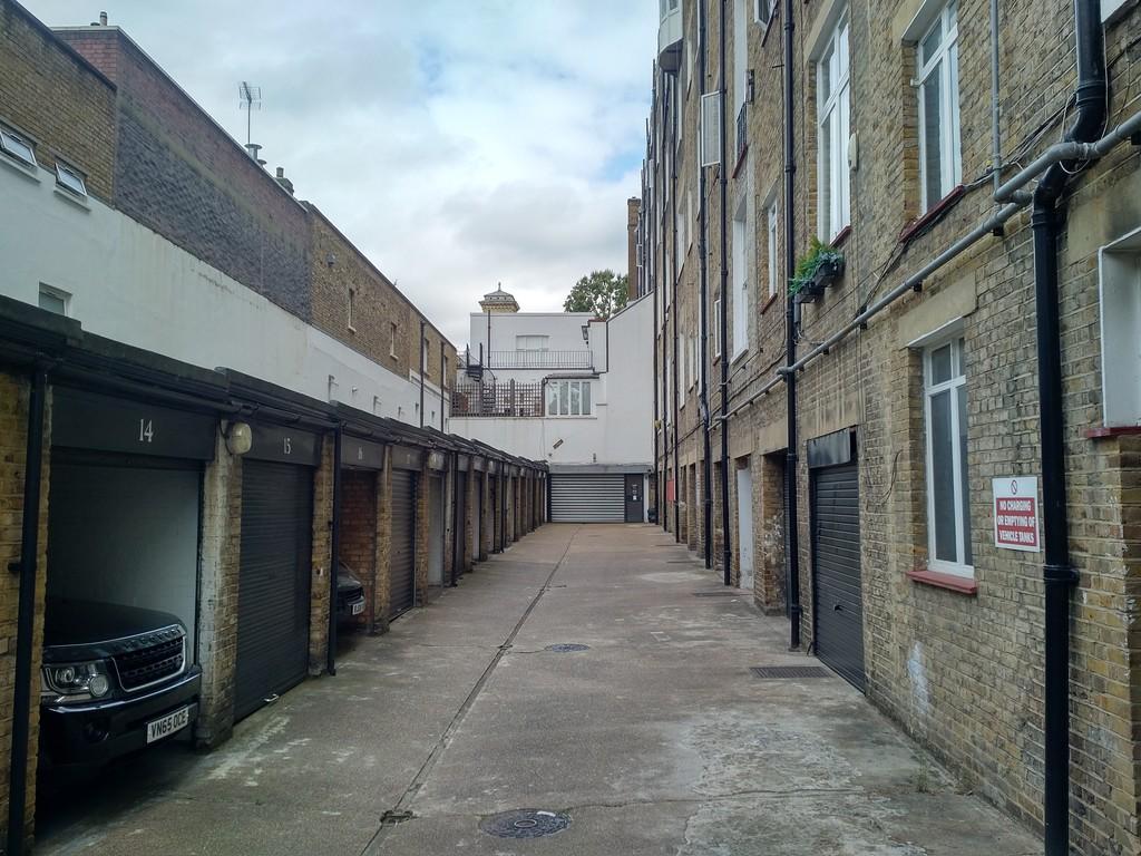 Entrance through lock ups to car park