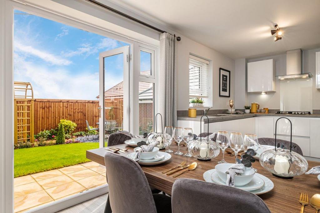 Photo of a kitchen diner with open French doors...