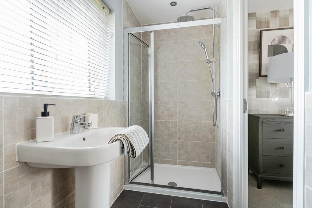 En suite to bedroom 1 with full width shower...