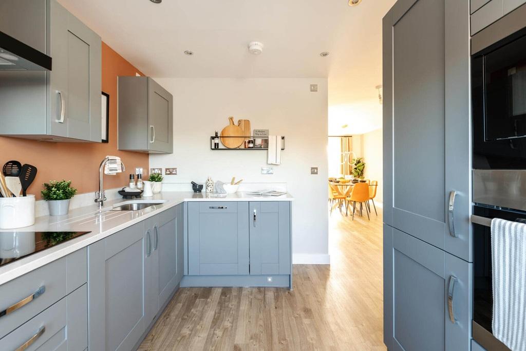 The bright and airy kitchen is at the front of...