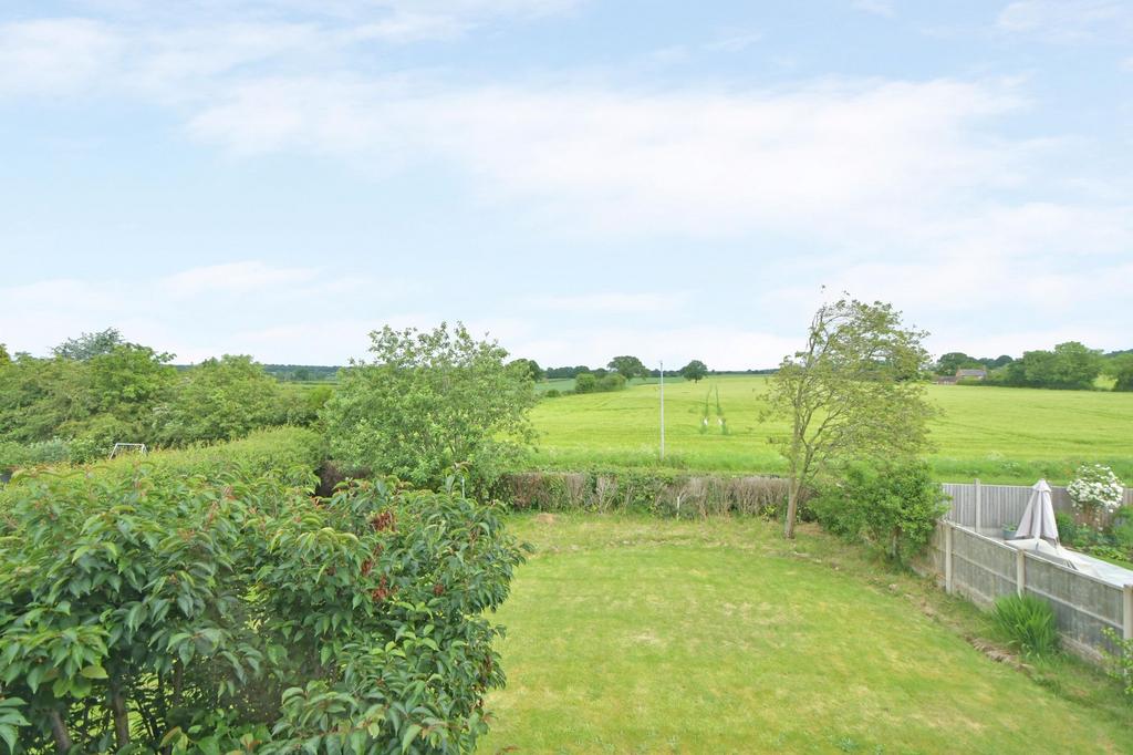 View of garden and farmland beyond