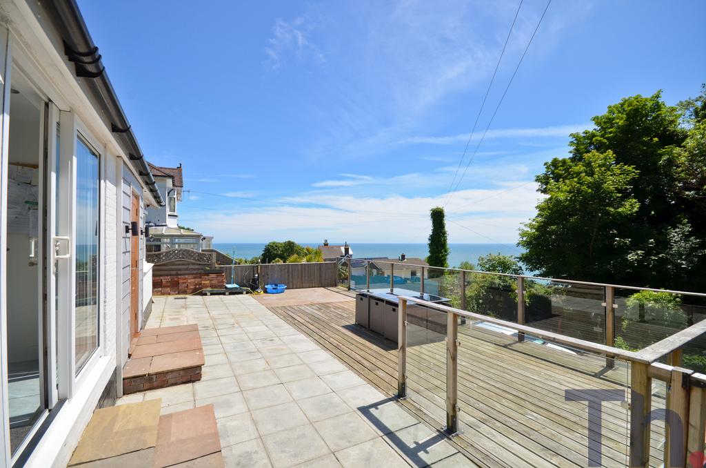 Decking to front with sea views.JPG