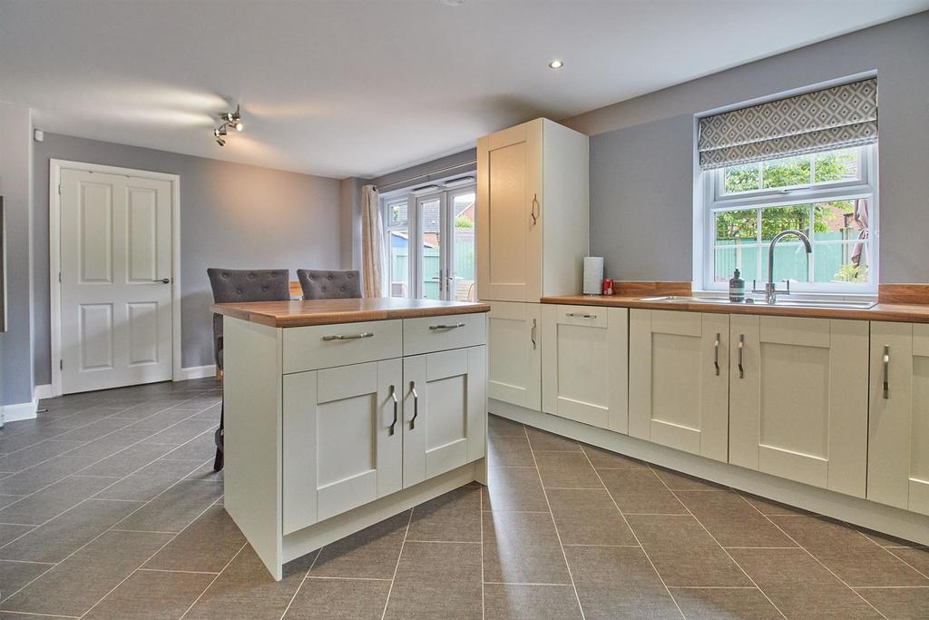 Open plan living dining kitchen to rear