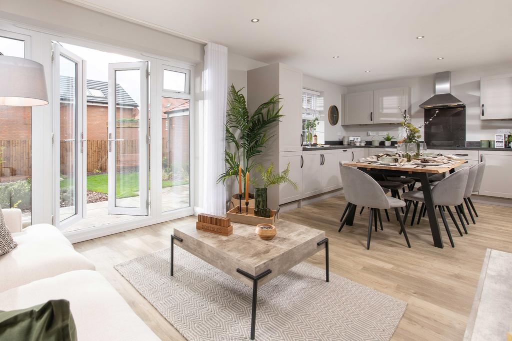 Open plan kitchen with French doors in the four...