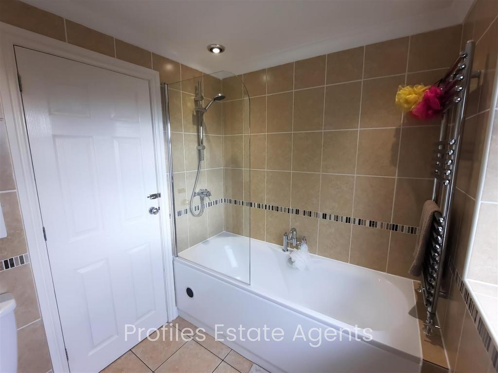 Luxury bathroom (rear) fully tiled