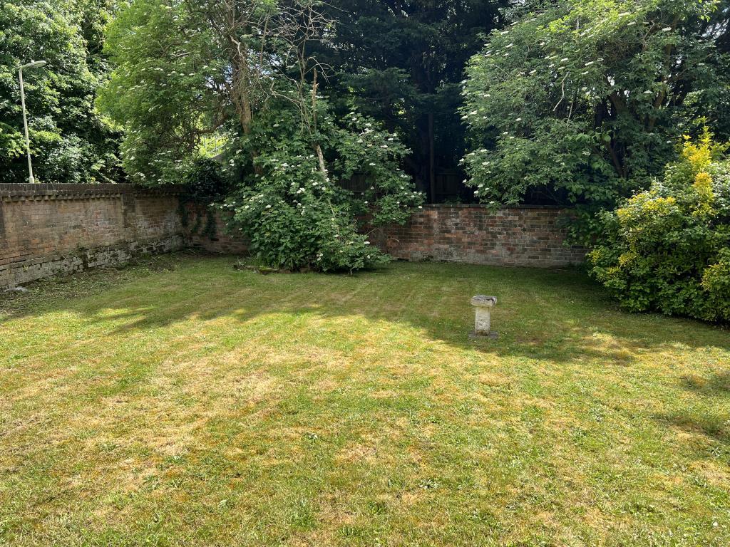 Front garden with grass lawn and flowers to side
