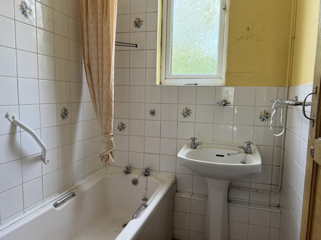 First floor bathroom with bath and hand basin
