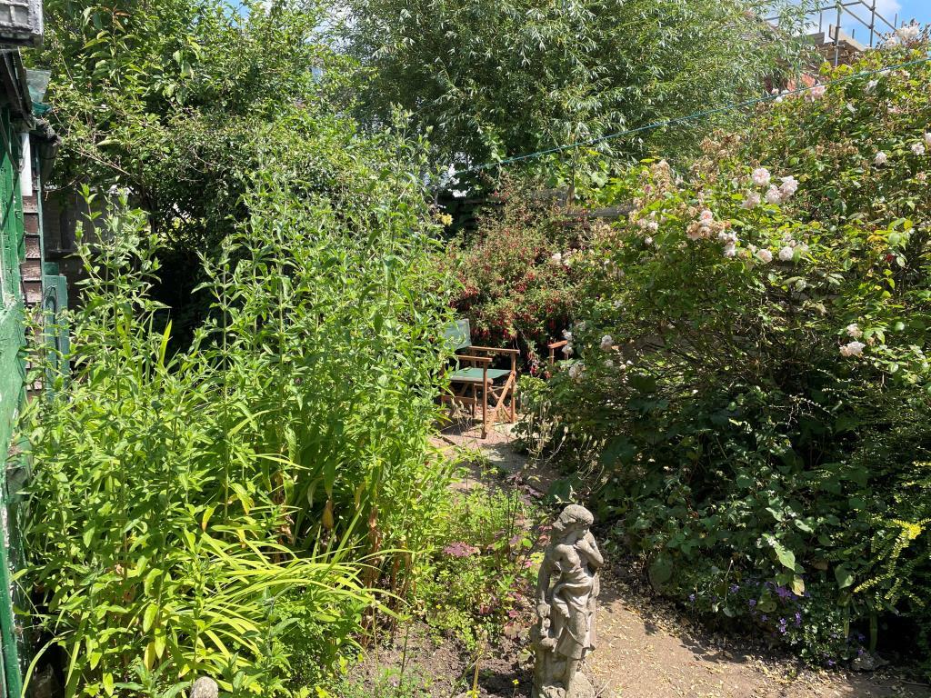 Garden from ground floor with patio and flower bor