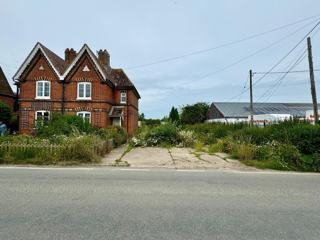 Front of property showing side garden and parking