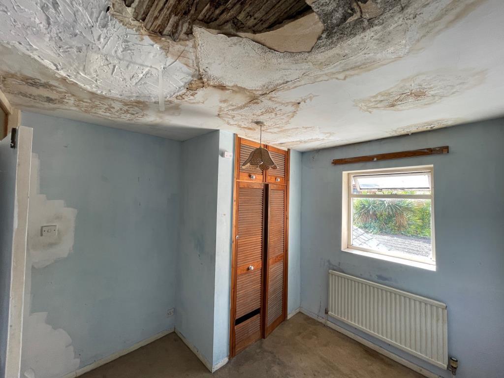 Bedroom 2 with boiler cupboard and damaged ceiling