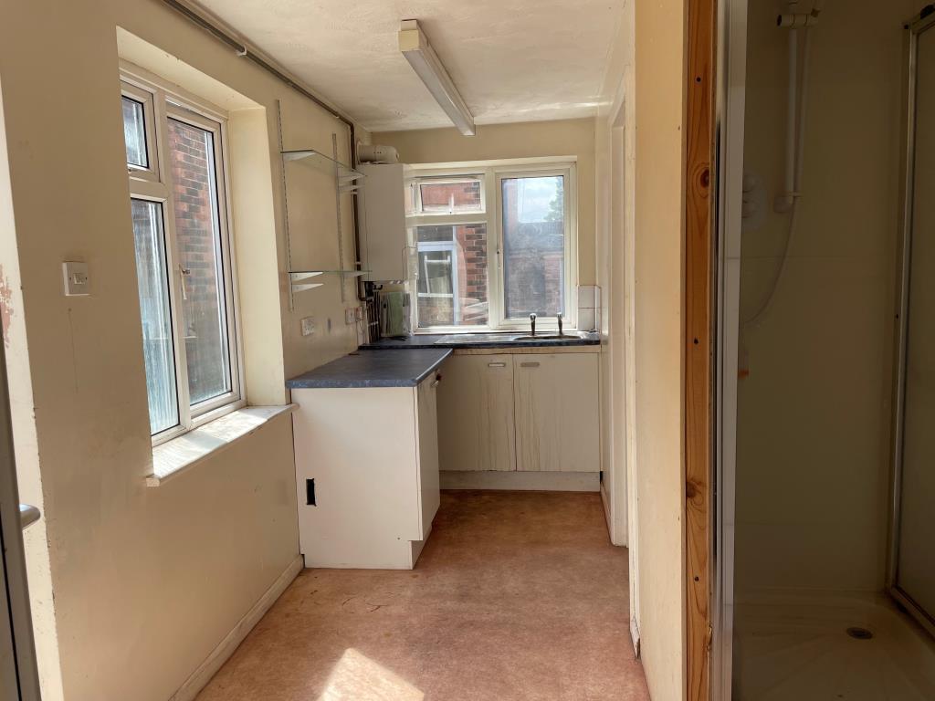 Rear kitchen with units and shoer cubicle