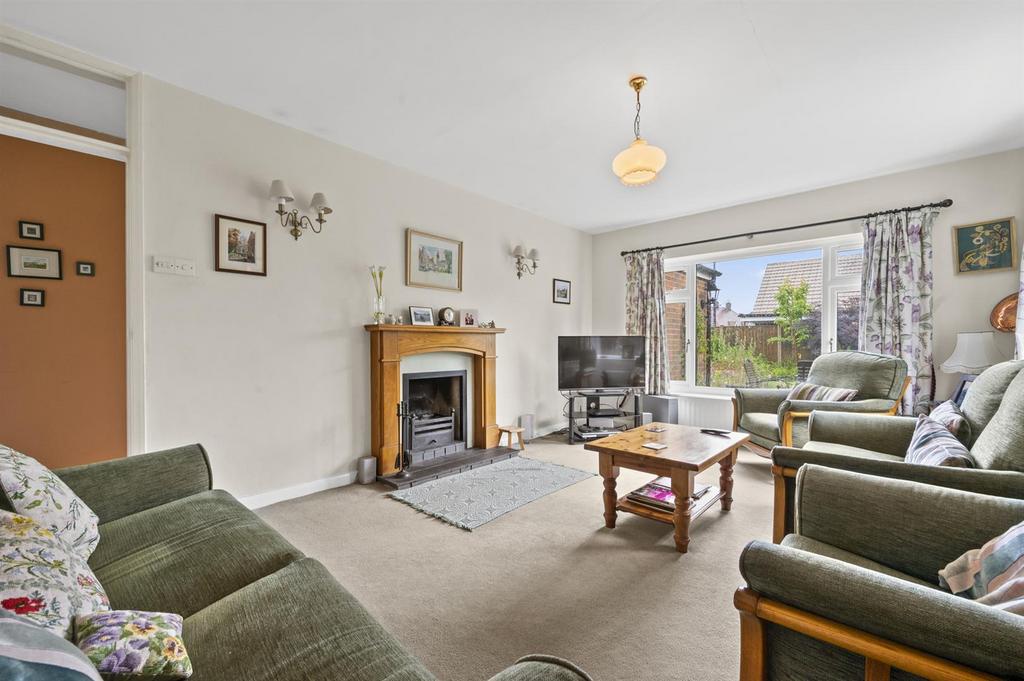 Sitting Room to fireplace and window.jpg