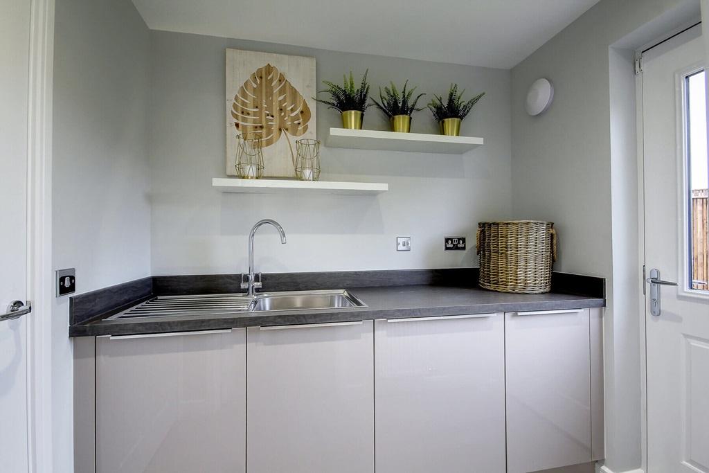 The utility room offers extra storage space