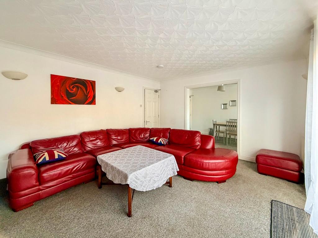 Communal lounge with access to garden and dining a