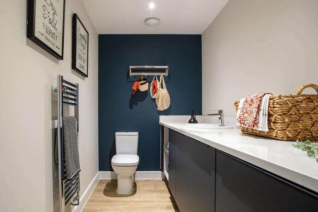 A guest cloakroom hosts space for laundry...