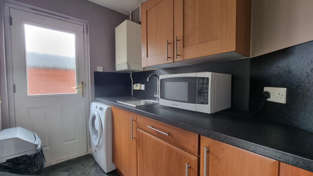 Utility room with white goods