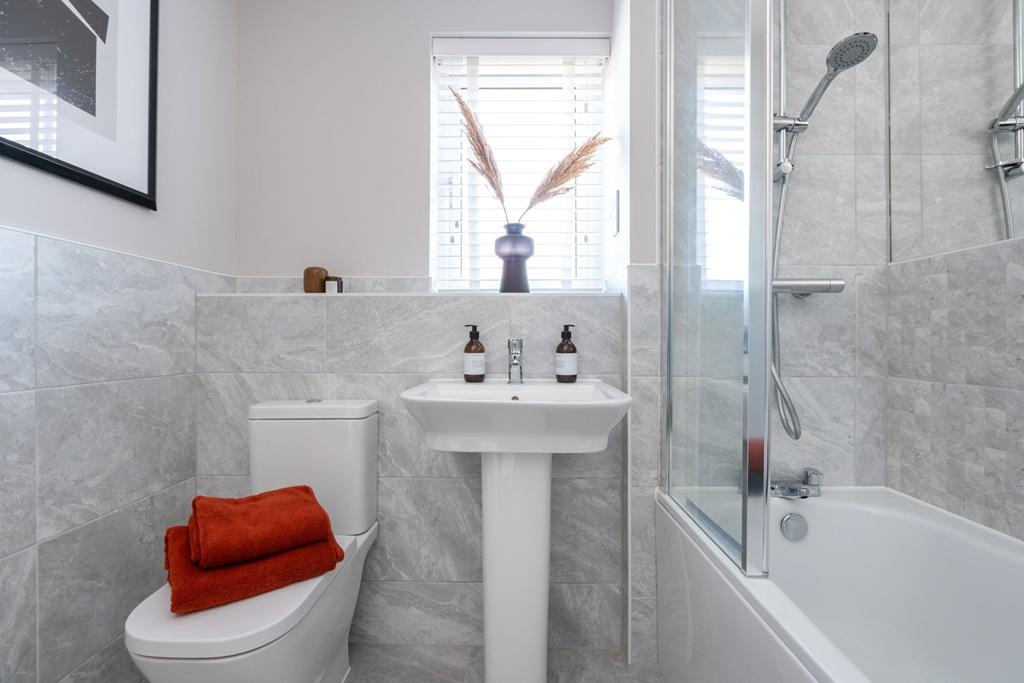 Family bathroom with shower over bath