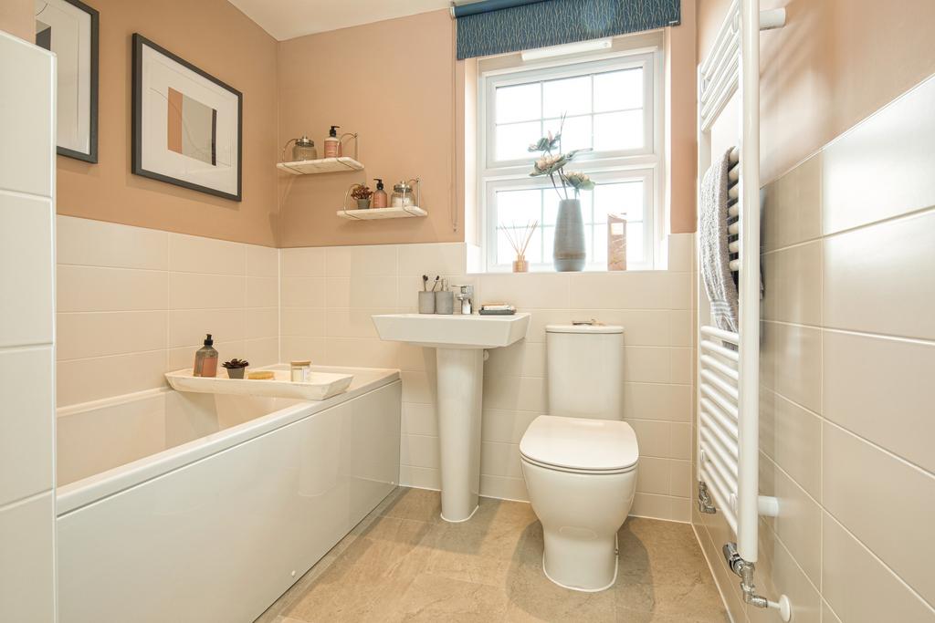 Bathroom with half tiled walls, painted blush...