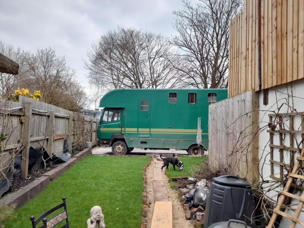 The huge lorry parked in the garden, demonstrates