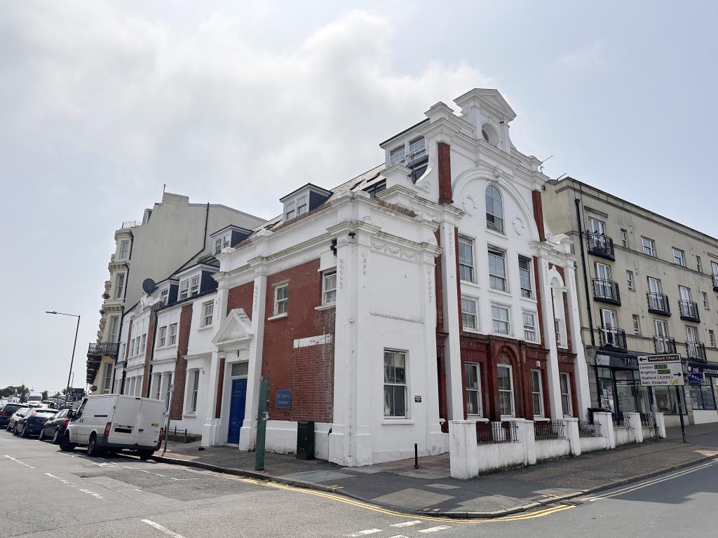 Substantial corner block with red brick and render