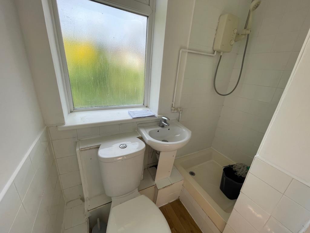 Shower room with WC and sink and Window to the rea