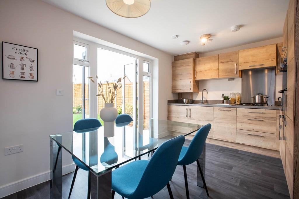 The kitchen/dining area boasts double doors out...