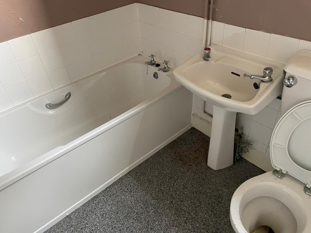 First floor bathroom with white units