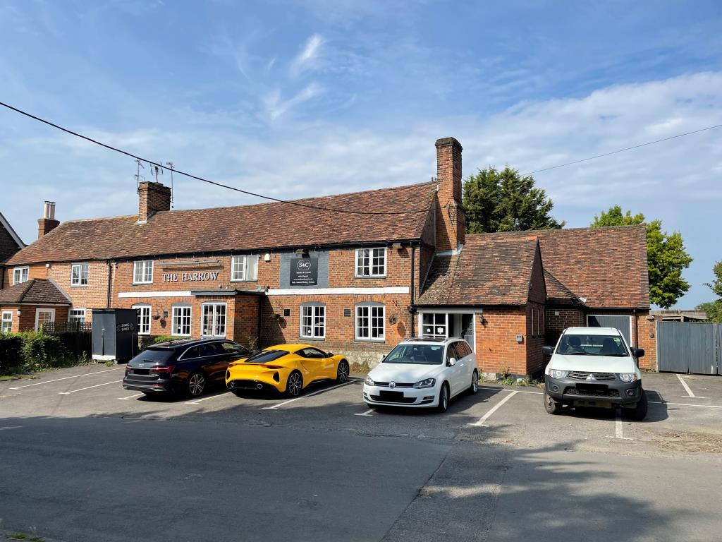 Former public house built from red brick and semi