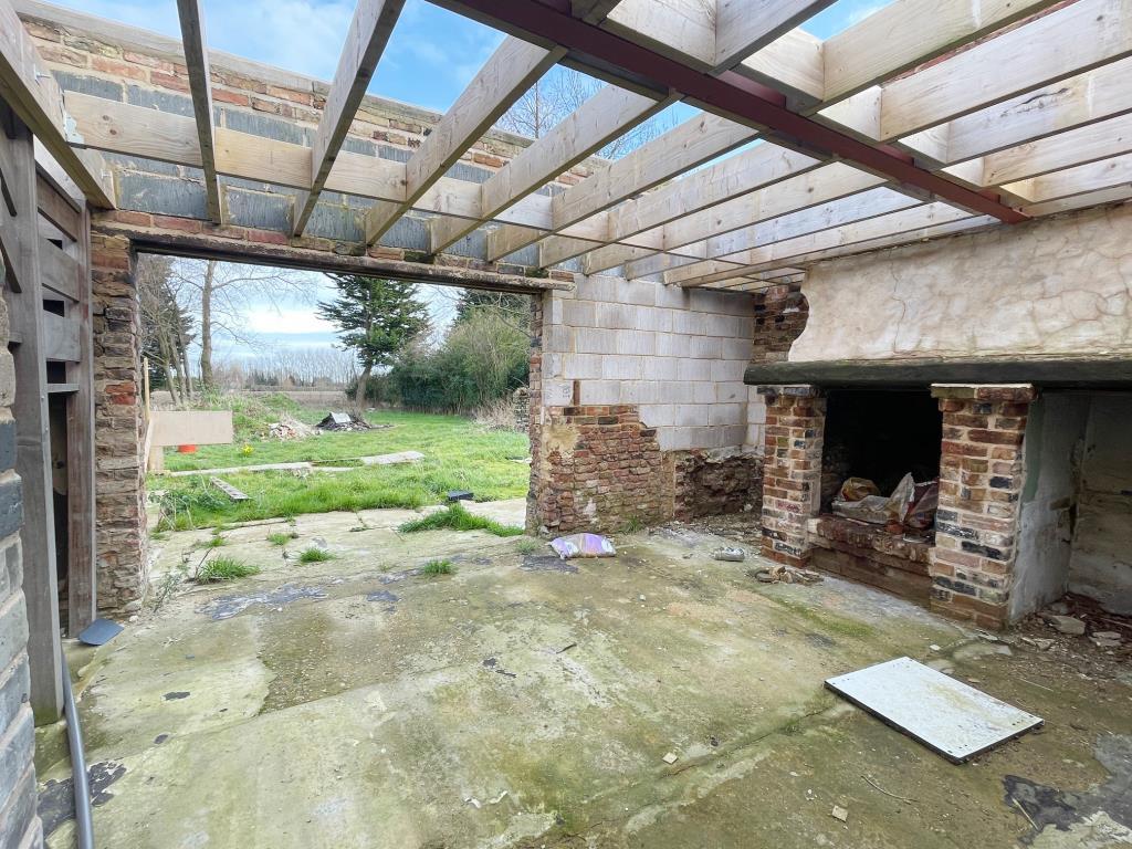 Fireplace and doorway looking out to the rear gard