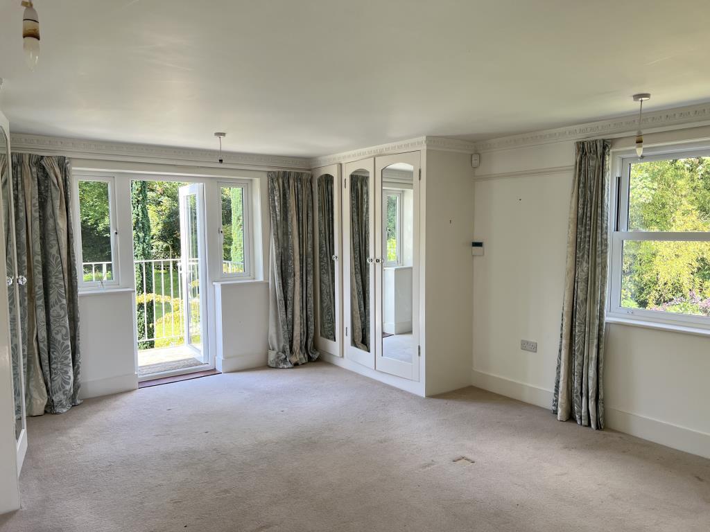 Main bedroom with view out to balcony