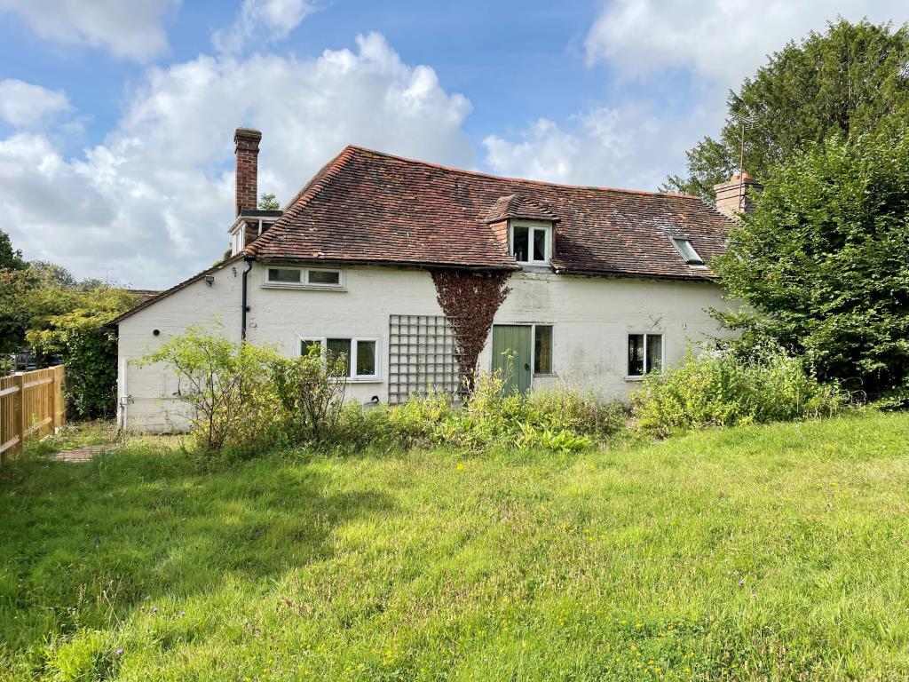 Front elevation with lawned garden and fence