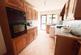 Dark wood effect base cabinets drawers and eye lev