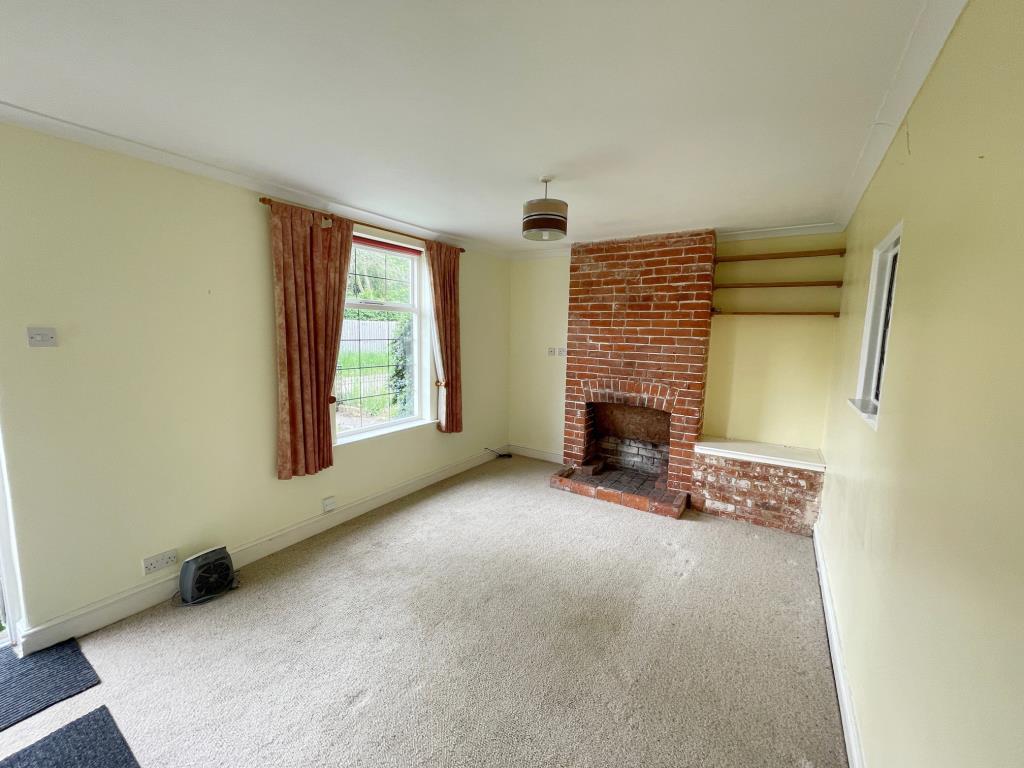 Living room with fireplace and window to front