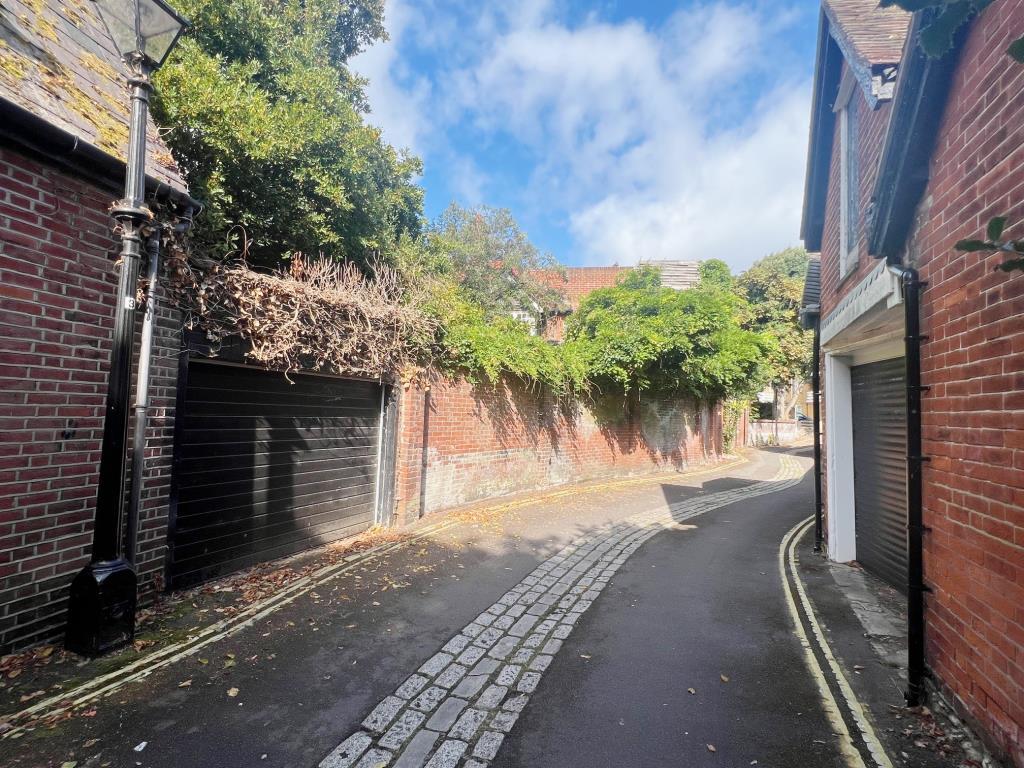Outside view of walled garden and garage