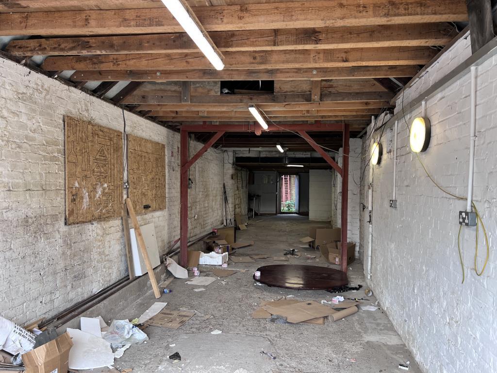 Inside view with concrete floor and brick walls