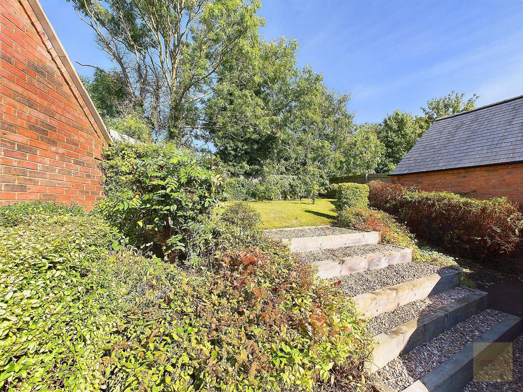 Steps leading to the rear garden next to the...