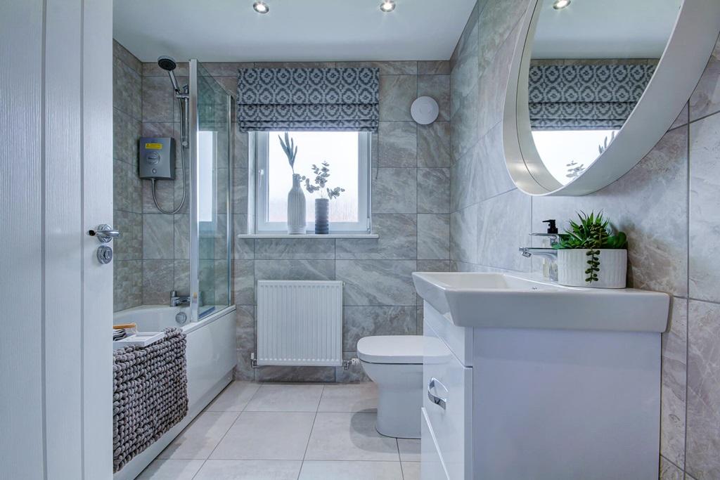 A family bathroom with shower over the bath