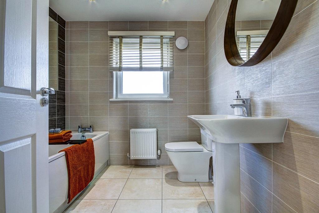 A family bathroom with shower over bath