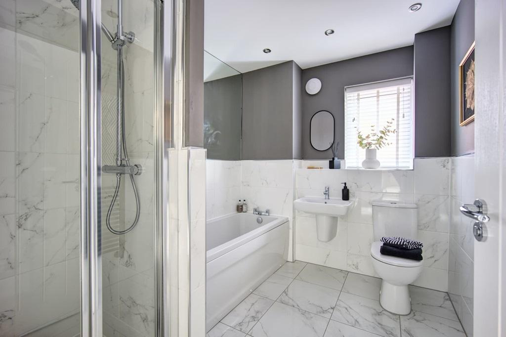 A practical family bathroom with both shower,...