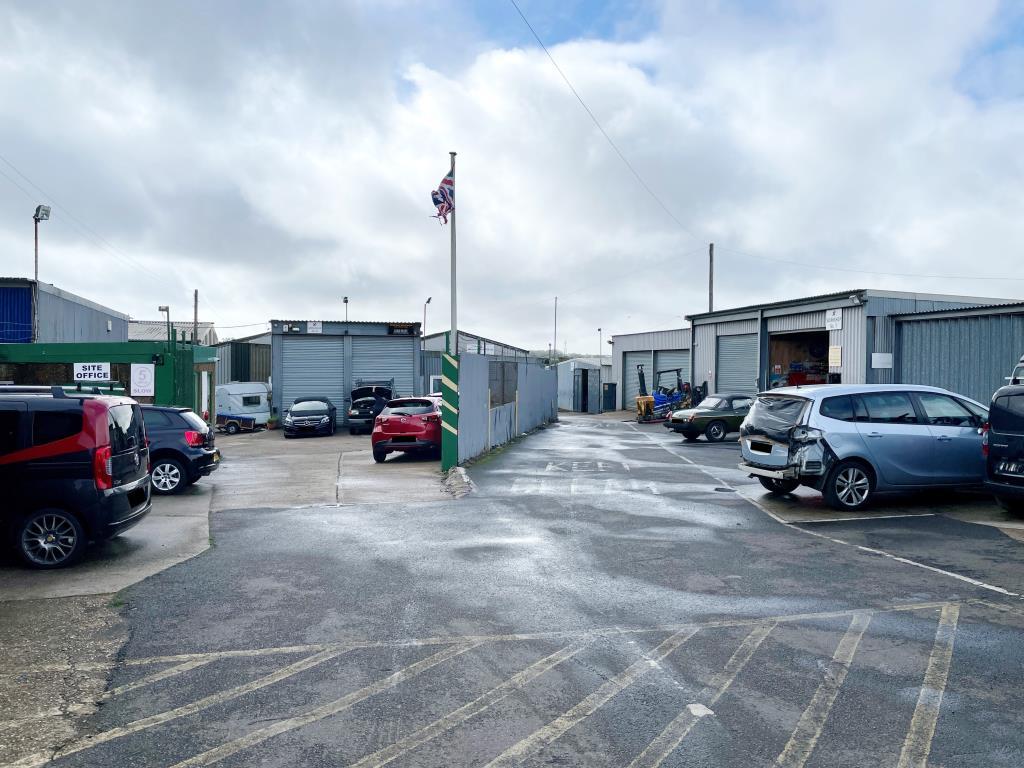 Entrance to yard with parking and site office