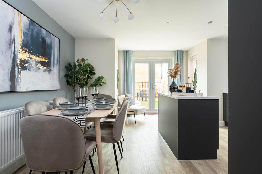 The open plan kitchen and dining area features...