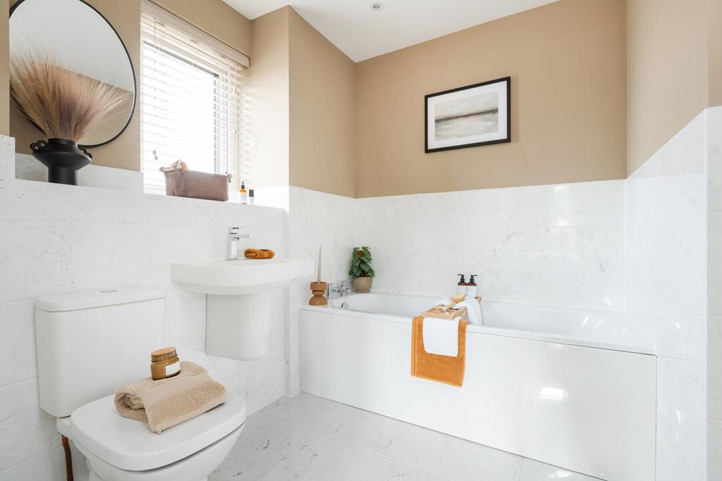 The main bathroom doubles as an ensuite to the...