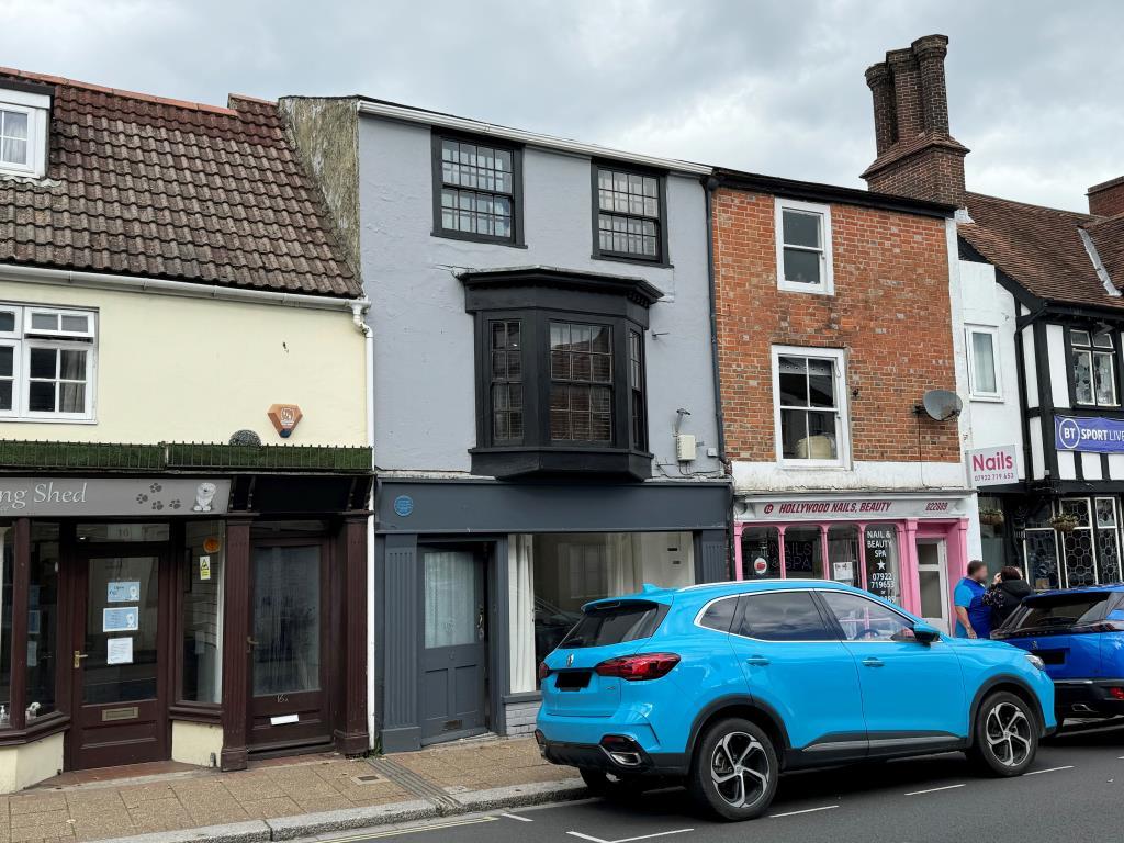 Terraced building painted grey with commercial uni