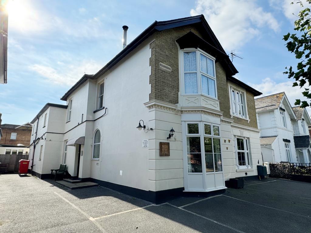 Detached building with car parking area to front