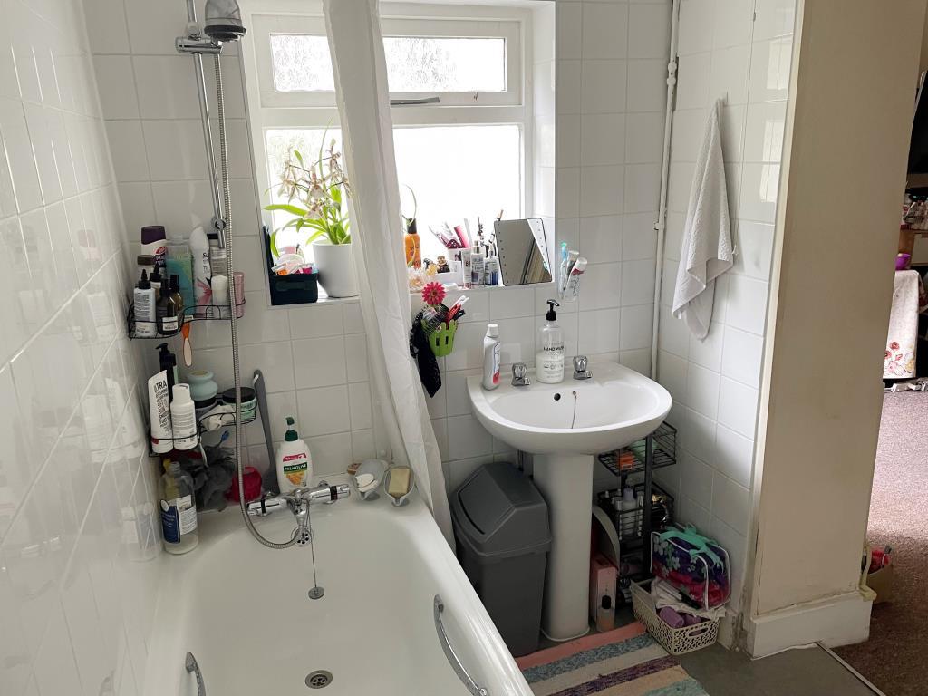 White bathroom suite with sink and window