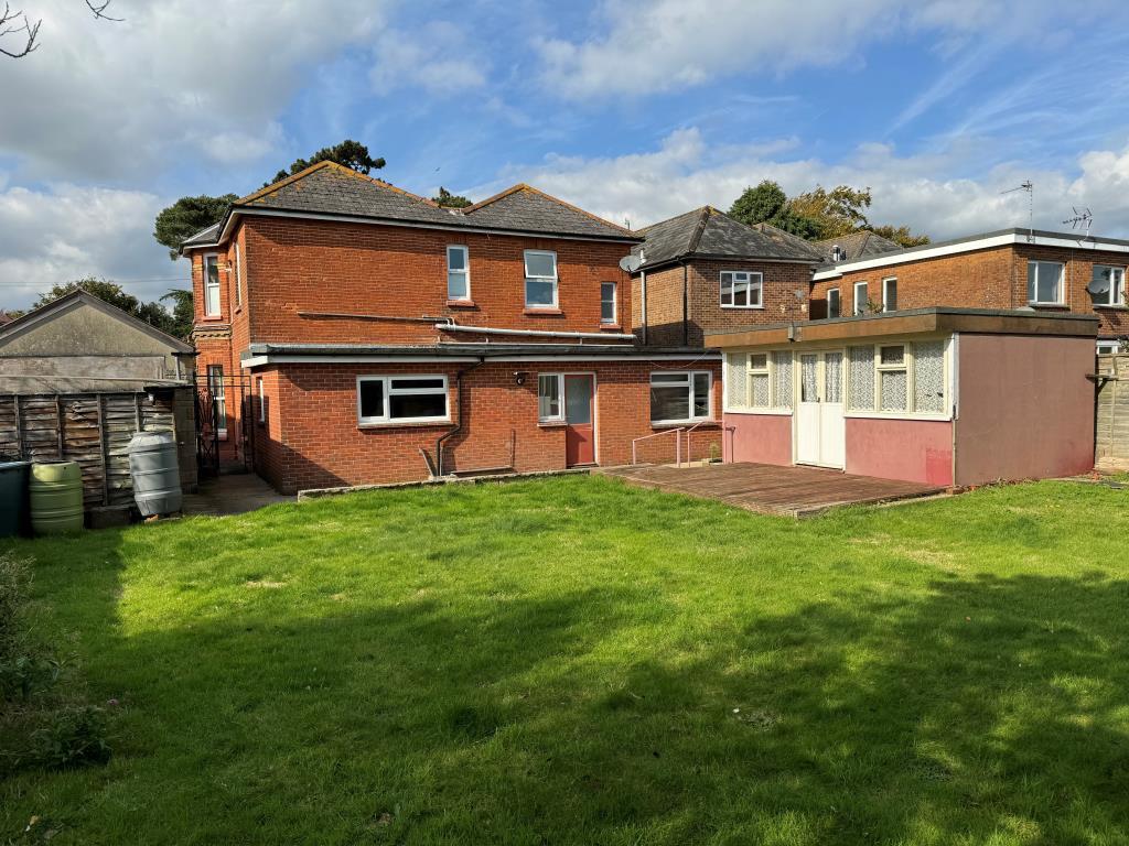 Garden showing rear of building and grass lawn