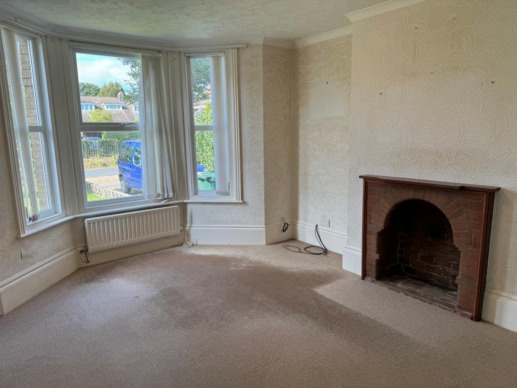 Room with fireplace and window to front garden